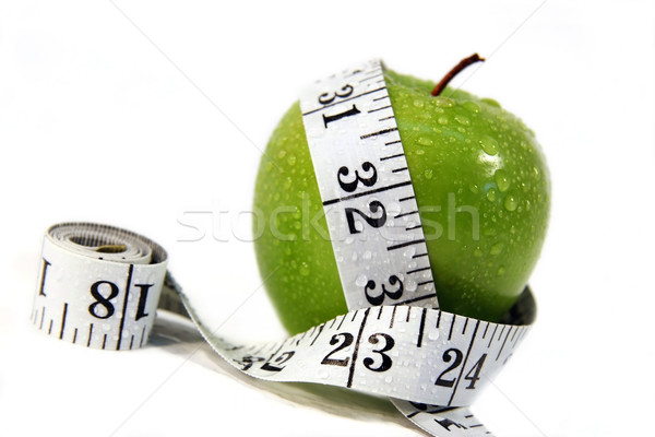Stock photo: Measurement tape wrapped around green apple