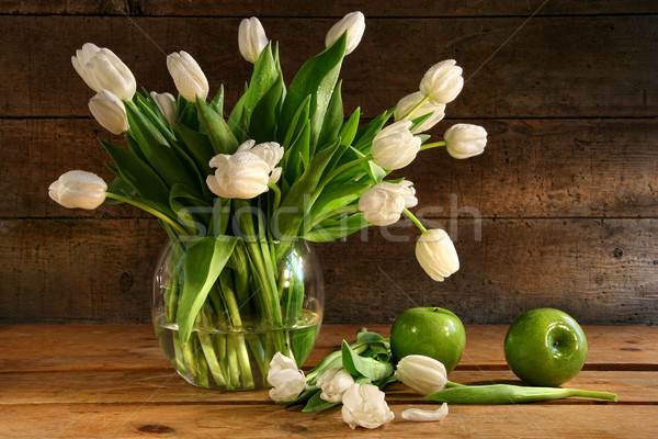 White tulips in glass vase on rustic wood Stock photo © Sandralise