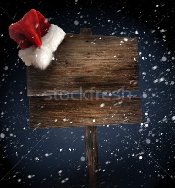 Wooden sign with santa hat on snowy background Stock photo © Sandralise