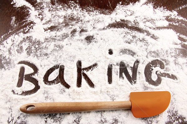 Word baking written in white flour on wooden table Stock photo © Sandralise