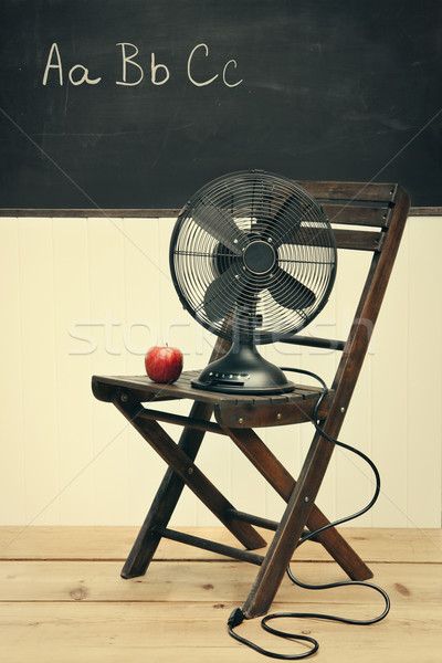 Old fan with apple on chair in school room Stock photo © Sandralise