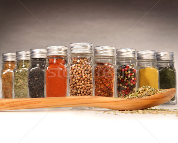 Spices in bottles with wooden spoon Stock photo © Sandralise