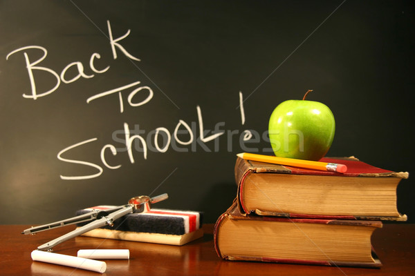 Stock photo: School books with apple on desk 