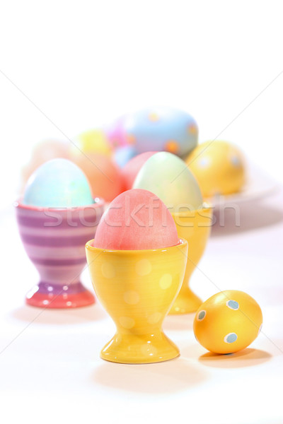 Egg cups with colored eggs on white  Stock photo © Sandralise