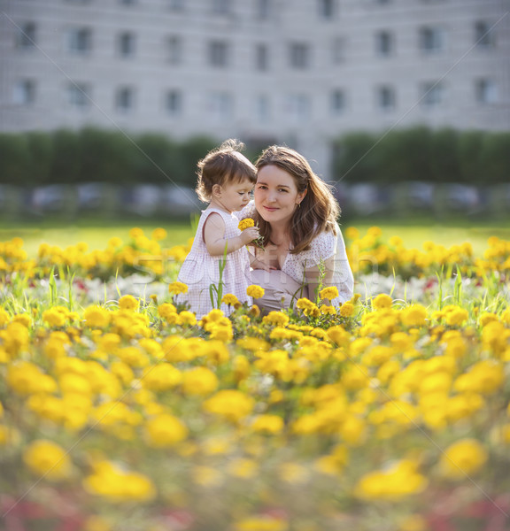 Boldog anya baba ül lánygyermek sárga virágok Stock fotó © sapegina
