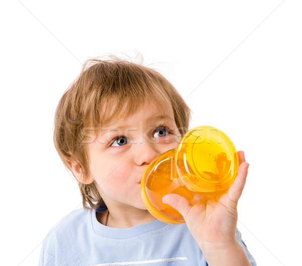жаждущий мальчика питьевой бутылку изолированный белый Сток-фото © sapegina
