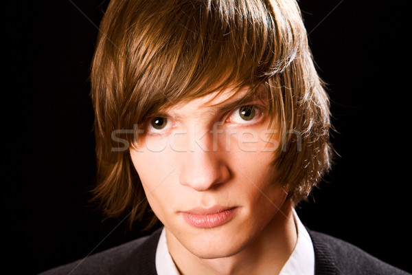 Genç genç ciddi adam siyah yüz Stok fotoğraf © sapegina