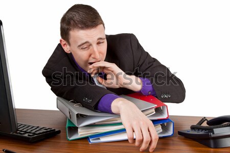 Túlóra fiatalember alszik mappák asztal iroda Stock fotó © Saphira