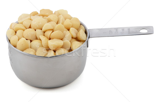 Macadamia nuts in a cup measure Stock photo © sarahdoow