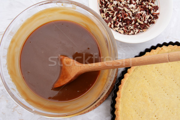 Making pecan pie - stirring the filling with a wooden spoon Stock photo © sarahdoow
