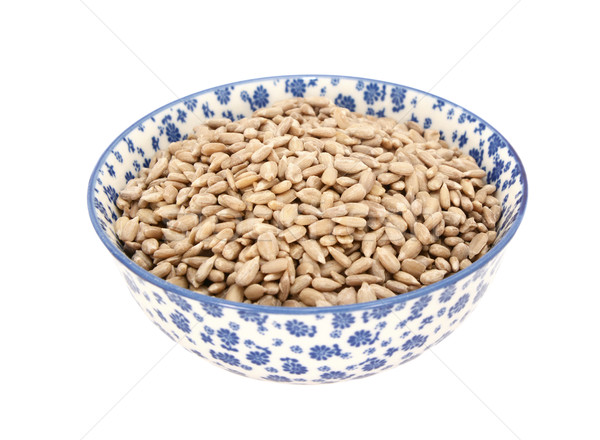 Sunflower seed hearts in a blue and white china bowl Stock photo © sarahdoow