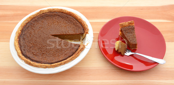 Pumpkin pie for Thanksgiving with a slice on a plate Stock photo © sarahdoow