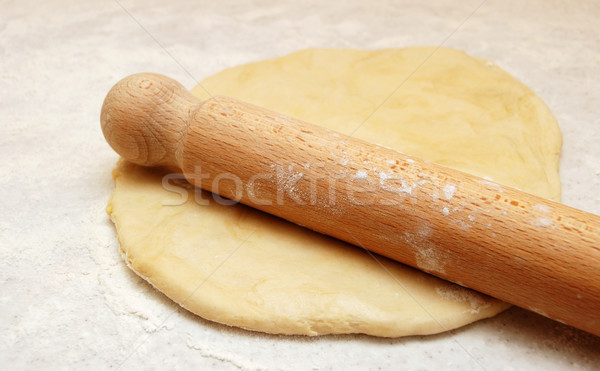 Wooden rolling pin dusted with flour, ready to roll out fresh pa Stock photo © sarahdoow