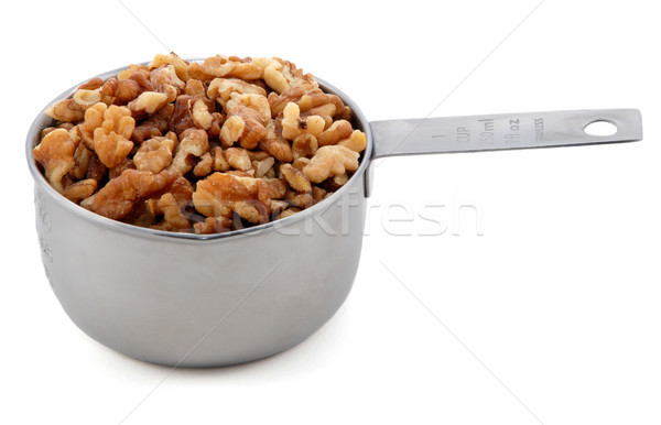 Chopped walnuts presented in an American metal cup measure Stock photo © sarahdoow