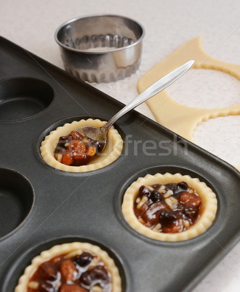 Using teaspoon to fill pastry cases with mincemeat Stock photo © sarahdoow