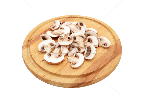 Sliced chestnut mushrooms on a wooden chopping board Stock photo © sarahdoow