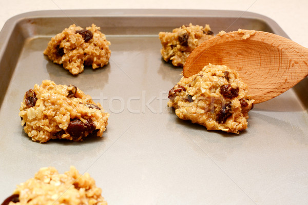 Spooning oatmeal raisin cookie dough onto a baking sheet Stock photo © sarahdoow