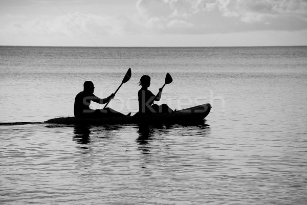 Kayakers silhouetted on the ocean Stock photo © sarahdoow