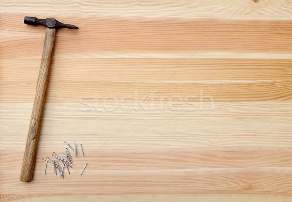 Hammer and metal panel pins on a woodgrain background Stock photo © sarahdoow