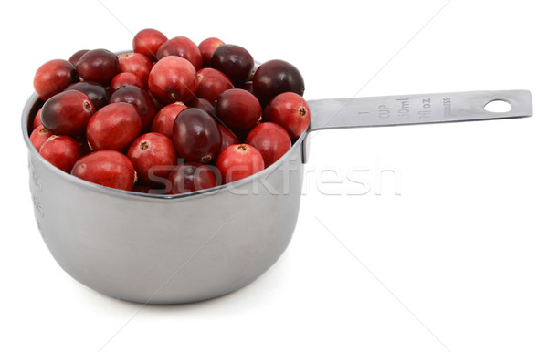 Stock photo: Whole fresh cranberries in a cup measure