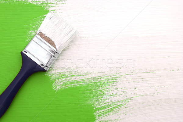 Paintbrush with white paint painting over green Stock photo © sarahdoow