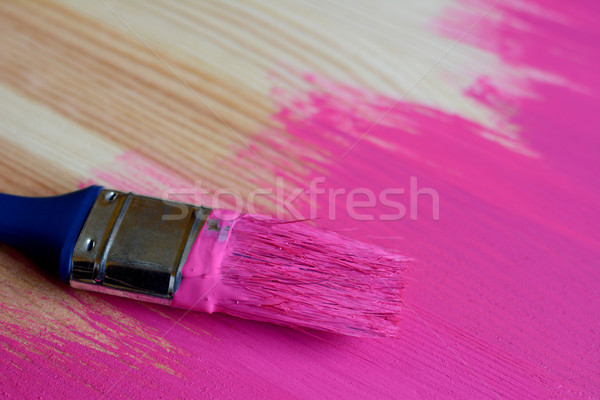Stock photo: Used paintbrush on half-painted pine board