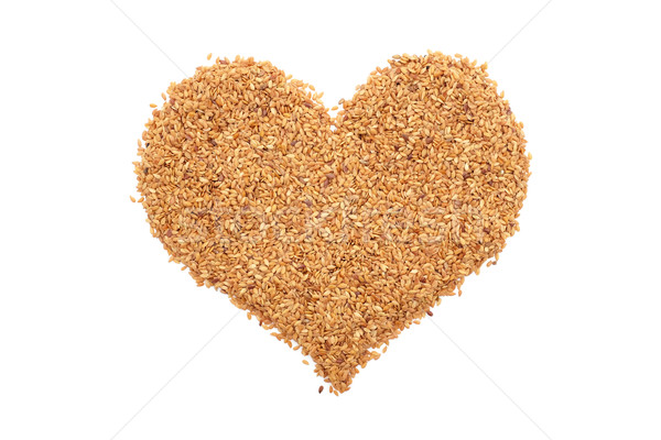 Golden linseed in a heart shape Stock photo © sarahdoow