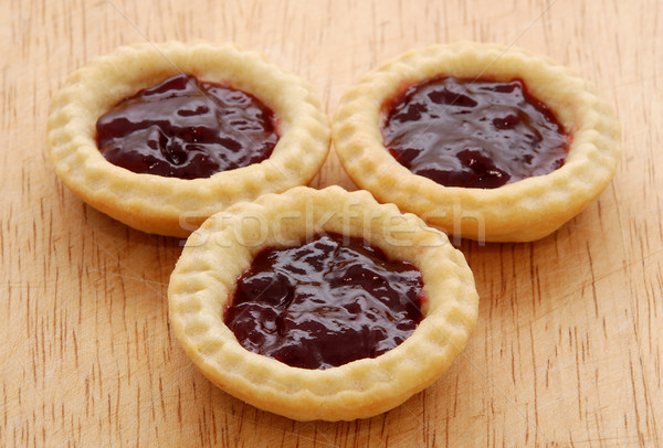 Three tasty jam tarts on a wooden table Stock photo © sarahdoow