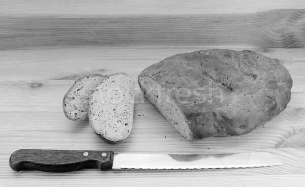 Bread knife with slices of bread cut from a loaf Stock photo © sarahdoow