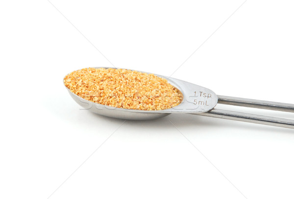 Garlic granules measured in a metal teaspoon Stock photo © sarahdoow