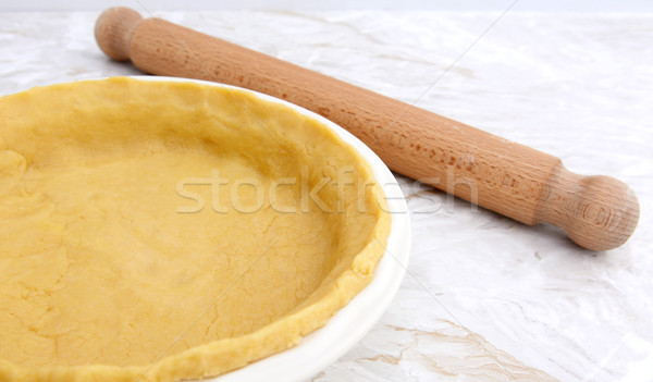 Pie dish lined with pastry with a rolling pin Stock photo © sarahdoow