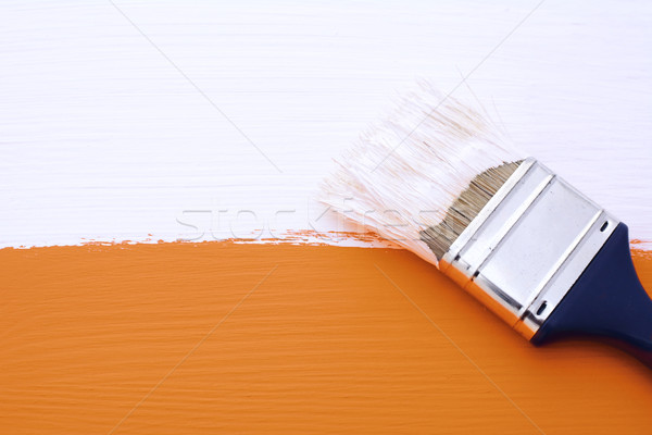 Painting orange surface with white paint Stock photo © sarahdoow