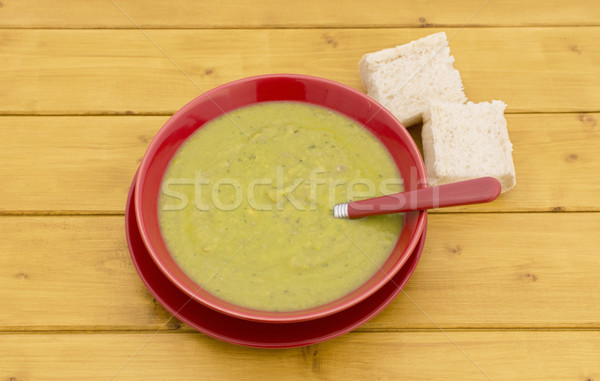 Chunks of bread with bowl of green soup Stock photo © sarahdoow