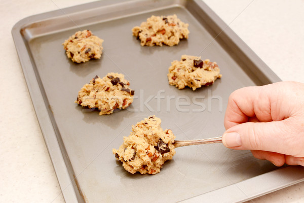 Spooning chocolate chip and pecan cookie dough Stock photo © sarahdoow