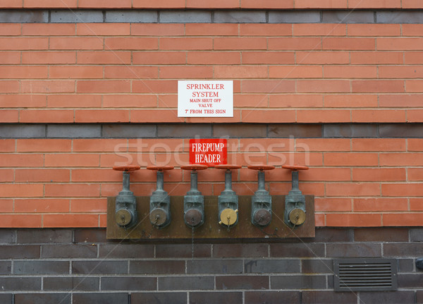 Firepump test headers on red brick wall Stock photo © sarahdoow