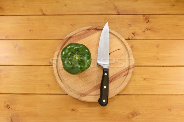 Stock photo: Green pepper with a knife on a cutting board
