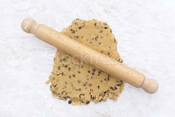 Cookie dough being rolled out with a wooden rolling pin Stock photo © sarahdoow