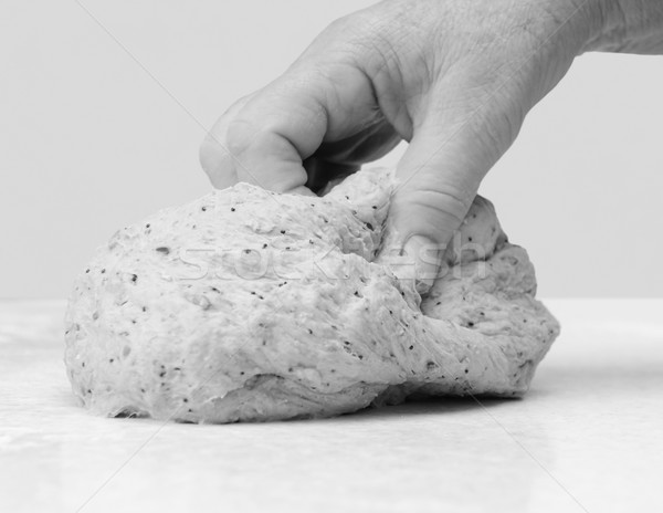 Stock photo: Woman's hand kneading bread dough