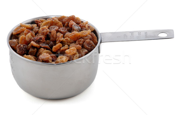 Stock photo: Sultanas presented in an American metal cup measure