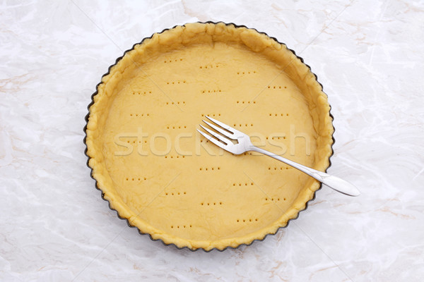 Stock photo: Fork rests in a pricked pastry pie crust