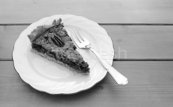 Slice of pecan pie on a china plate with a fork Stock photo © sarahdoow