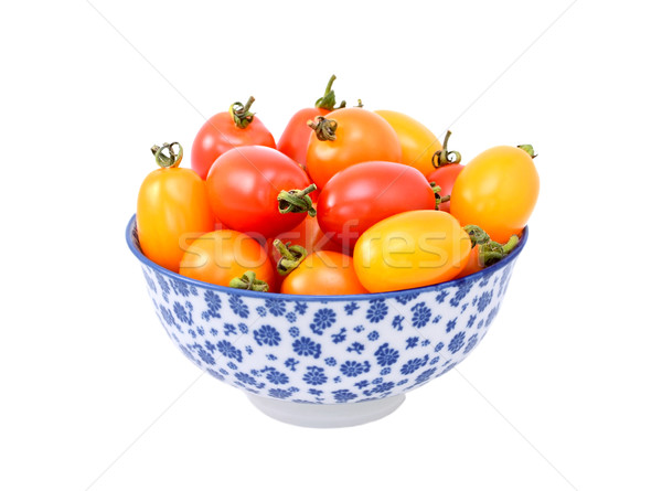 Red and yellow plum tomatoes in a blue and white china bowl Stock photo © sarahdoow