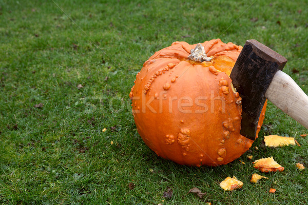 Axe hacking into a large orange pumpkin Stock photo © sarahdoow