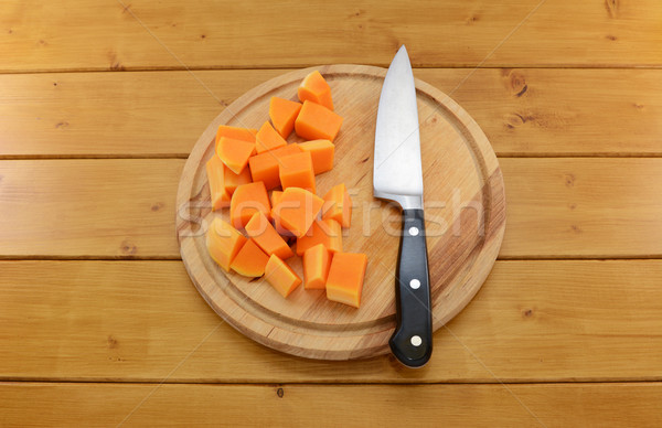 Chopped butternut squash with a knife on a chopping board  Stock photo © sarahdoow