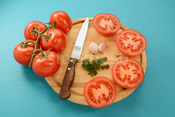 Stock photo: Tomatoes cut for roasting with knife, garlic and thyme