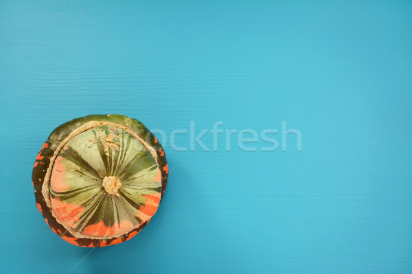 Green and orange Turks turban squash on a teal background Stock photo © sarahdoow