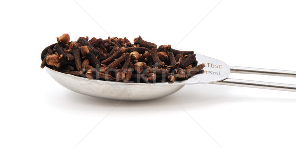 Whole cloves measured in a metal tablespoon Stock photo © sarahdoow