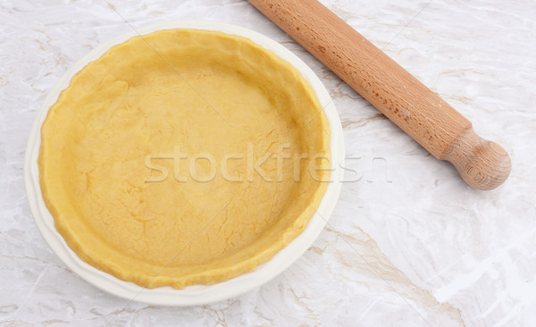 Pie dish lined with fresh pastry with a rolling pin Stock photo © sarahdoow