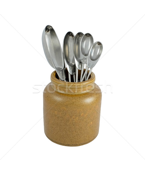 Stock photo: Metal measuring spoons in a ceramic pot