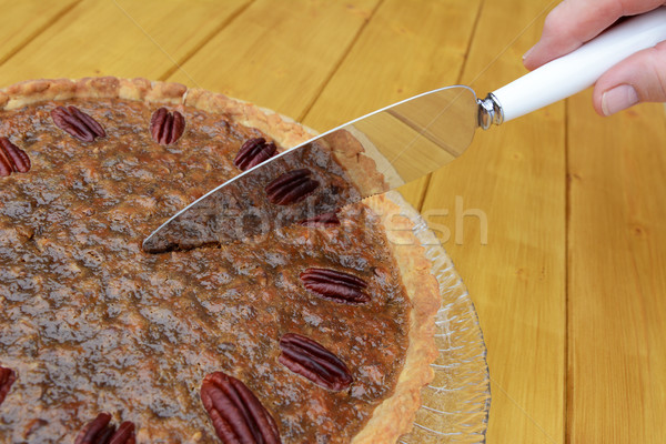 Woman cuts into a home-made pecan pie Stock photo © sarahdoow